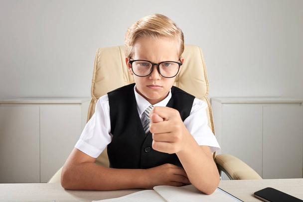Angry little boy in glasses showing fig gesture - Photo, Image