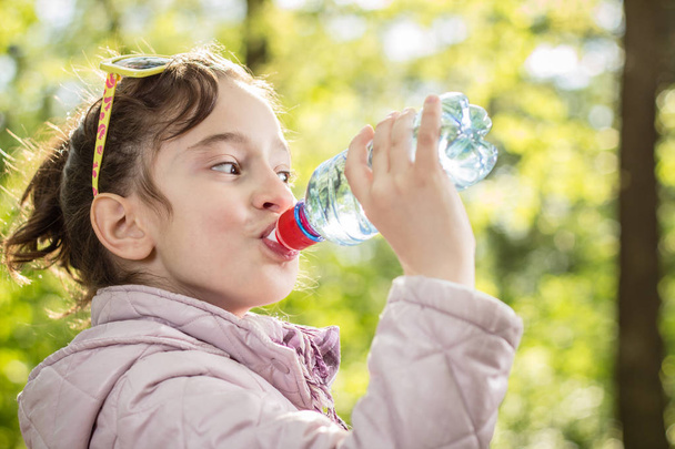 Photo of little girl drinking water - Foto, Bild
