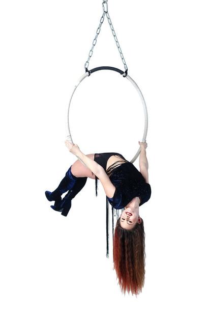 Young woman performs the acrobatic elements in the air ring. - Photo, Image