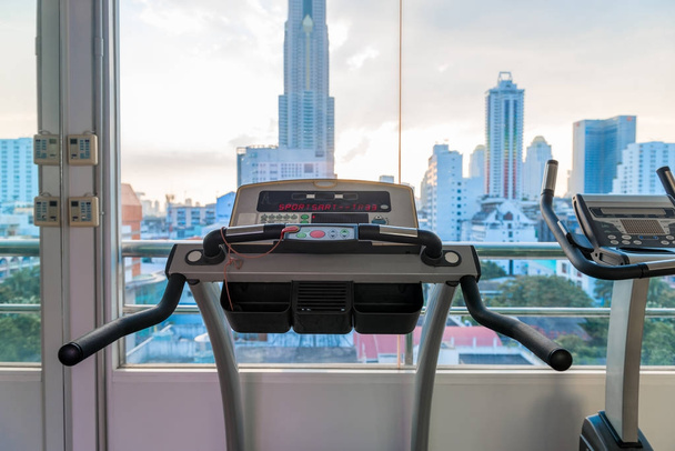 fitness equipment in the gym with a view of the city - Valokuva, kuva
