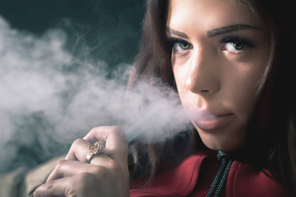 Young, beautiful girl smoke a hookah at club - Fotó, kép