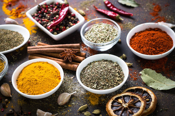 Set of Various spices on dark stone table. - Zdjęcie, obraz