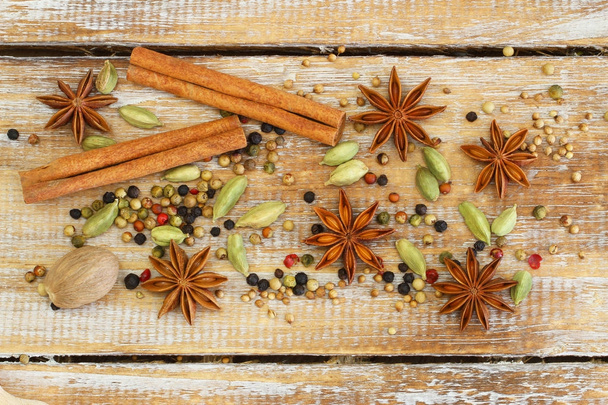Selection of spices and herbs on wooden surface - Фото, зображення
