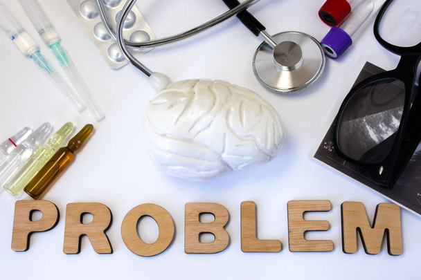 Brain problems concept photo. 3D figure of brain is near word problem and set of medical equipment and drugs. Idea of problems with mental or cognitive brain normal vital activity and function organ - Photo, Image