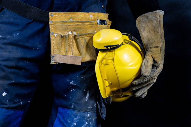 Workwear for production workers. A construction worker holding p - Photo, Image