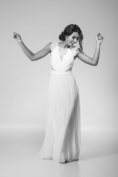 Portrait of a beautiful female model in a light dress - Photo, Image