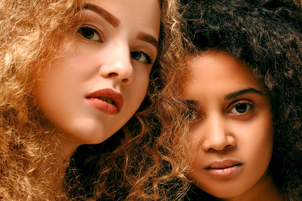 Portrait of two curly girls. Afro and blond - Фото, изображение