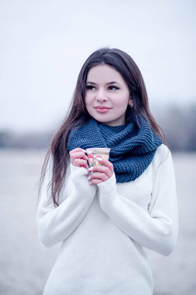 Красивая молодая женщина с бокалом кофе зимой
 - Фото, изображение