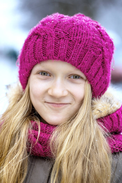 winter - little smiling girl outdoors at the snowfall tim - Fotografie, Obrázek