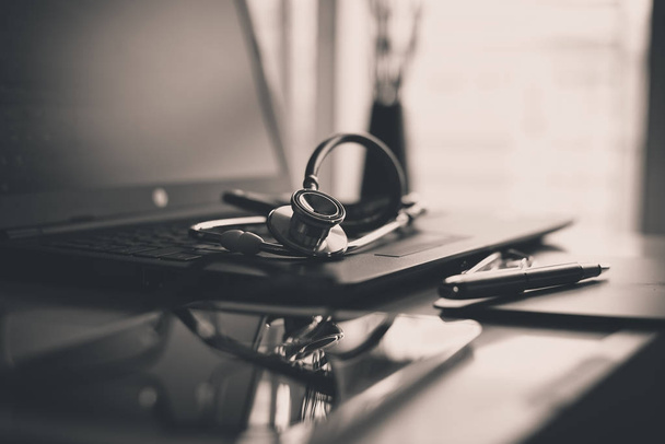 Close up of red stethoscope on desk,Healthcare and medical concept,Selective focus,Black and white toned - Φωτογραφία, εικόνα