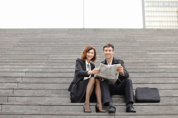 engineers male and female reading article about company in - 写真・画像