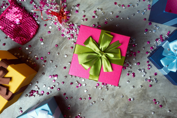 Top view of colorful gift boxes with little pink stars on grey background - Fotografie, Obrázek