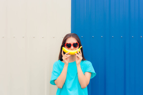 Heart Shape Sunglasses Woman with Funny Big Banana Smile - 写真・画像