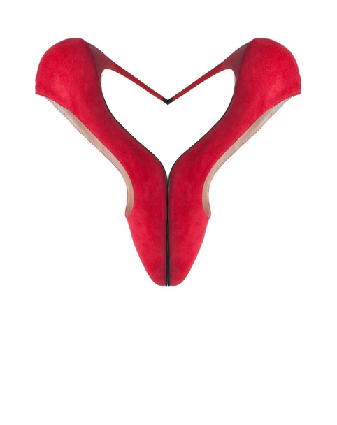 Red suede shoes stacked in the form of heart on white background - Foto, Imagen