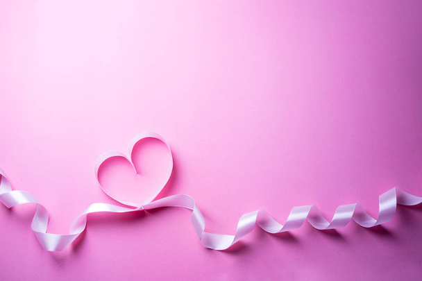 Valentines Day background with pink heart. Heart shape from ribbon - Φωτογραφία, εικόνα