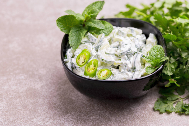 Indian cucumber raita with yoghurt, mint, cilantro. Greek tzatzi - Fotó, kép