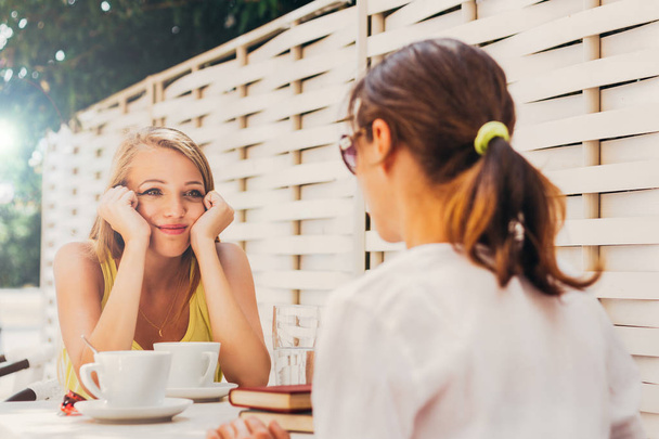 Two women enjoying in summer cafe - Foto, Imagem