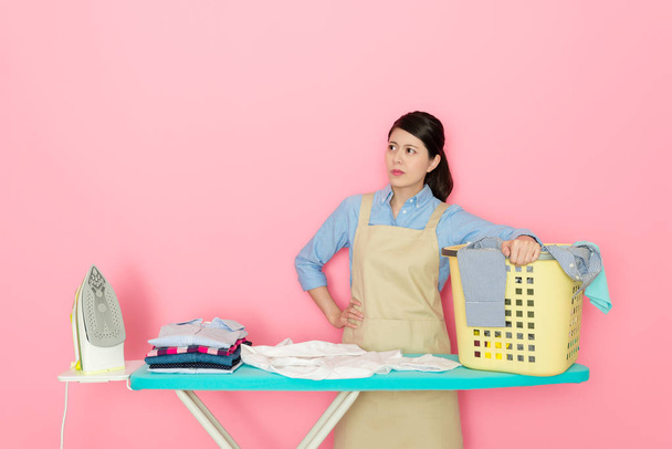 confident female housekeeper ironing clothing - Valokuva, kuva