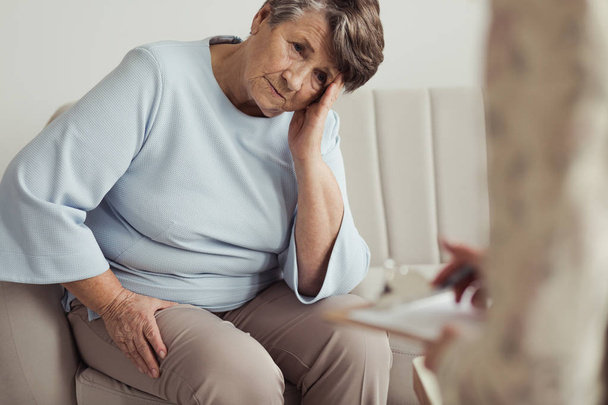 Worried elderly woman with headache - Фото, зображення