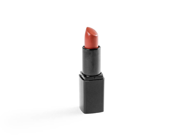 Lipstick in black case on white background. Closeup - Фото, зображення