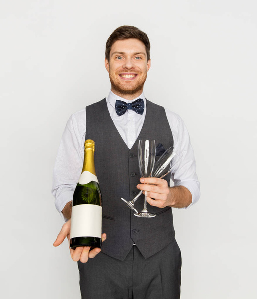 man with bottle of champagne and glasses at party - Fotó, kép