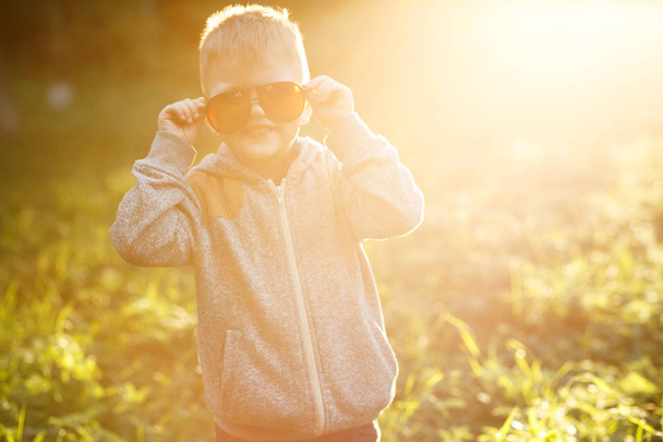 attractive little Boy in sunglasses at summer time  - Фото, изображение