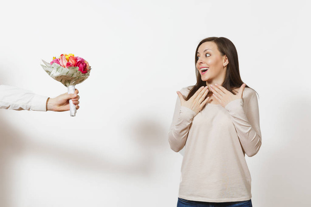 Delight woman, man hand aside with bouquet of beautiful roses flowers isolated on white background. Copy space for advertisement. St. Valentine's Day, International Women Day birthday holiday concept. - 写真・画像