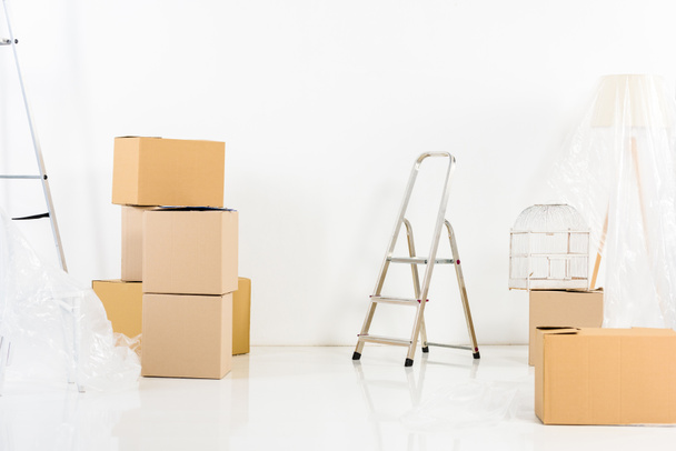 ladders and boxes in new empty apartment - Foto, imagen