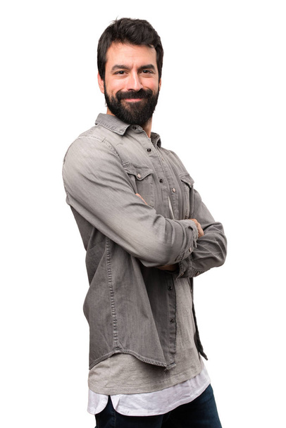 Handsome man with beard with his arms crossed on white backgroun - Фото, зображення