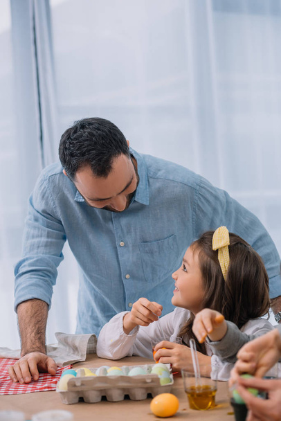 young father painting easter eggs with daughter - Φωτογραφία, εικόνα