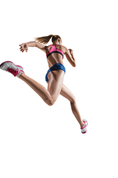 The studio shot of high jump female athlete is in action - Photo, Image