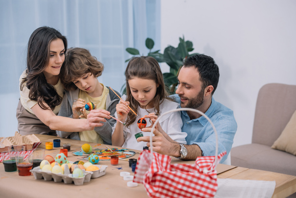 young family painting eggs for easter at home - Valokuva, kuva