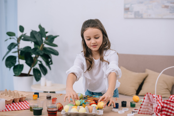 happy little child painting easter eggs - Photo, Image