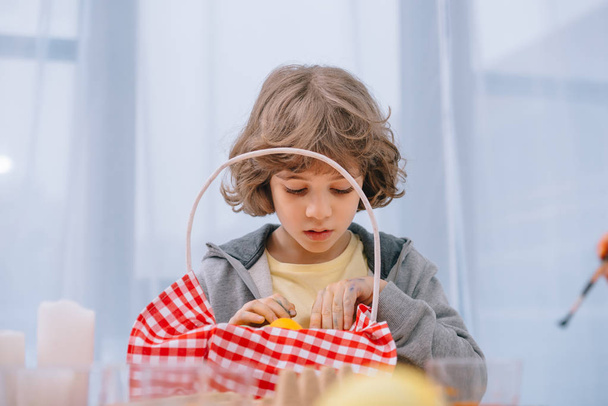 sad little kid looking at basket with red napkin - 写真・画像