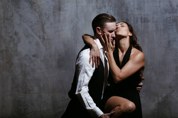 Giovane bella donna in abito nero e uomo danza tango
 - Foto, immagini