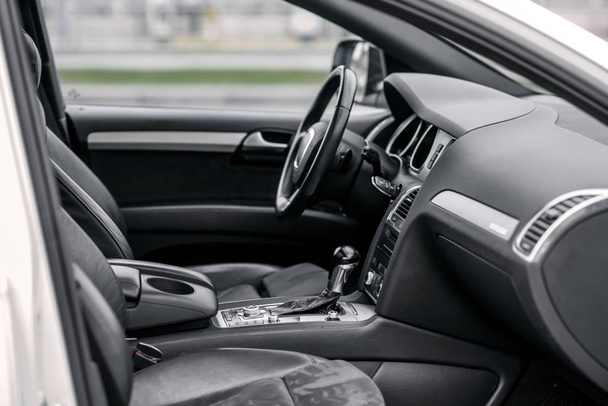 Luxury car interior. Steering wheel, shift lever and dashboard. - Fotó, kép
