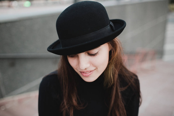 Young pretty woman girl portrait in black hat - Fotó, kép