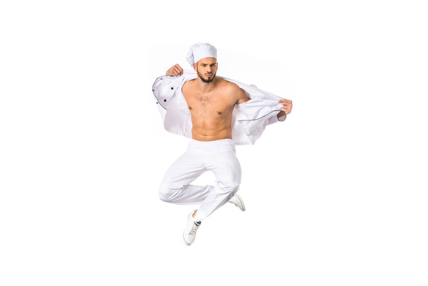 handsome young bare chested chef jumping isolated on white  - Valokuva, kuva