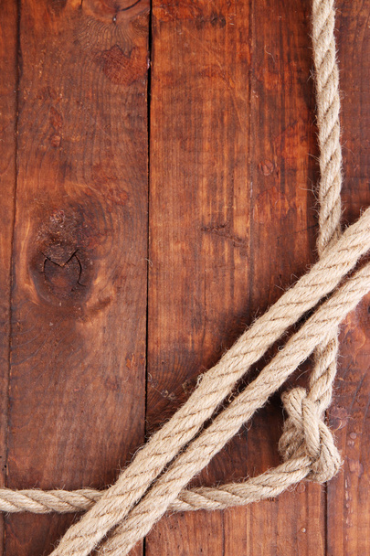 Frame composed of rope on wooden background - Photo, image