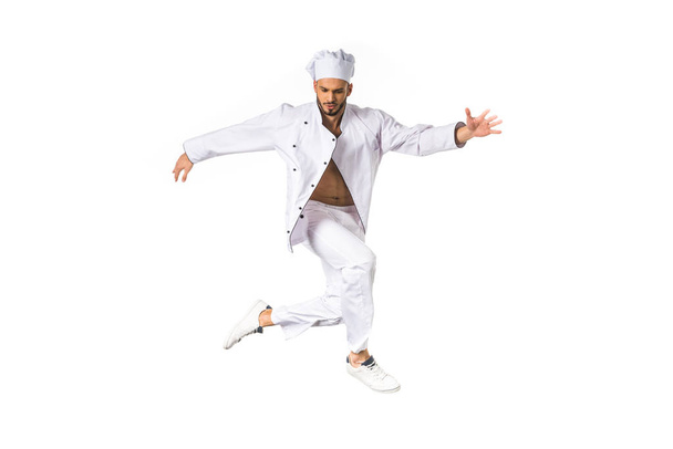 young chef in uniform jumping isolated on white - Valokuva, kuva