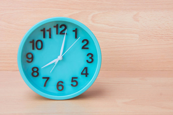 Green clock on wood background , Clock to tell time Create a plan to manage the hustle of life or work. - Photo, Image
