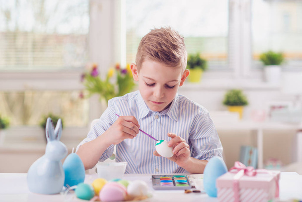 Happy child boy having fun during painting eggs for easter in sp - Zdjęcie, obraz