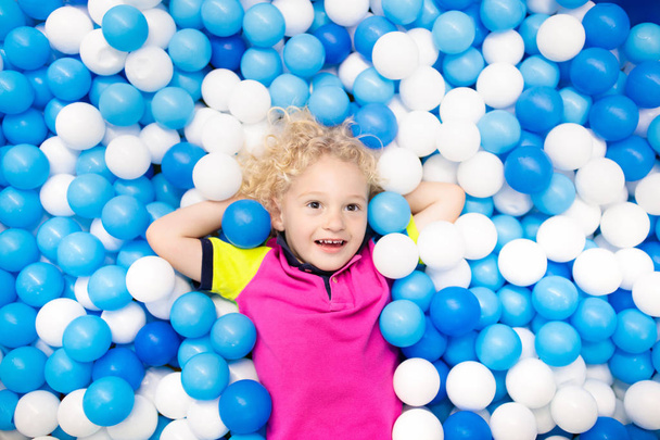 Kids play in ball pit. Child playing in balls pool - Photo, Image