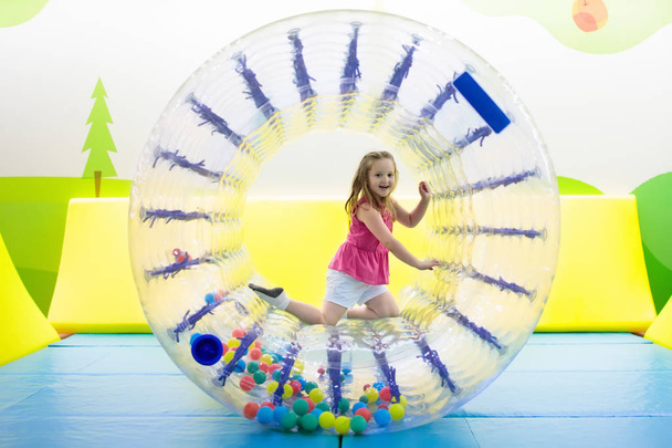 Child play in roller wheel. Kids on trampoline.  - Фото, зображення