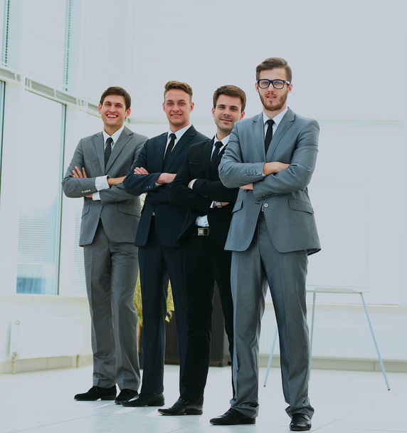 Business team in a line smiling at the camera. - 写真・画像