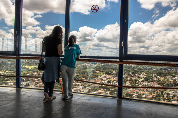 Curitiba, Parana, Brazil, January 03, 2018. Tourists observe the 360 degree view of the 109 meter high in Panoramic Tower Viewpoint in the Merces neighborhood in Curitiba, Parana state - Photo, Image