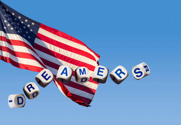 Dromers concept met behulp van spelling letters tegen een blauwe lucht en vlag - Foto, afbeelding