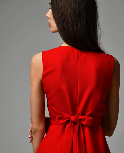 Closeup details of woman red dress bow knot - 写真・画像