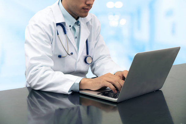 Doctor working on desk with laptop - Photo, Image