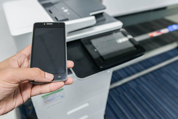 Using smart phone with printer to print the document - Photo, Image